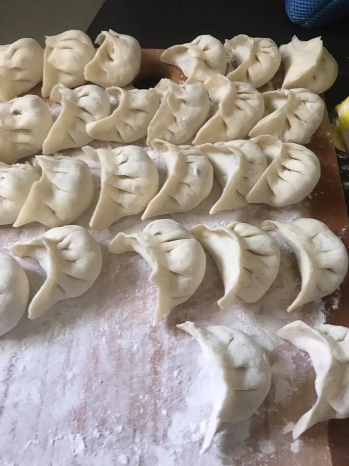 Fresh Momo resting before being cooked on a cutting board at the kitchen.