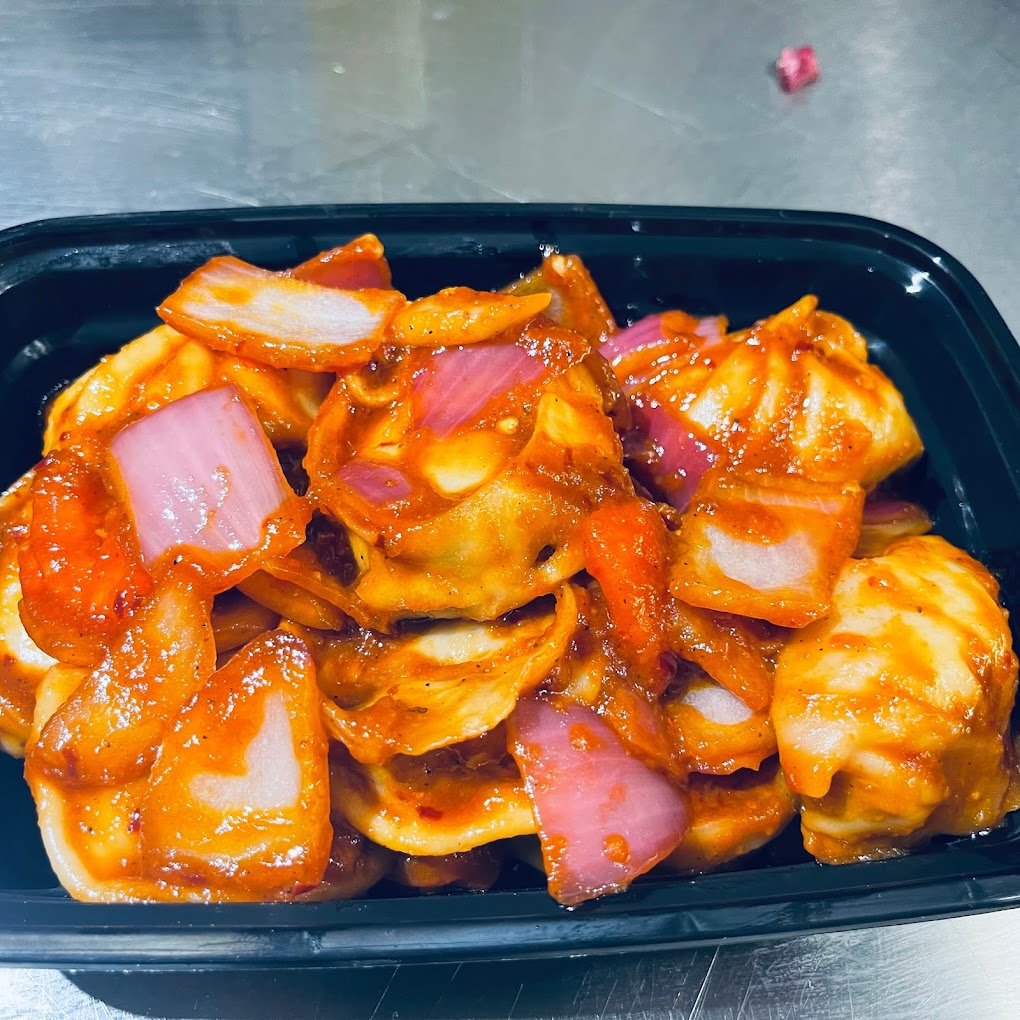 Spicy Momo, in a black bowl in the kitchen